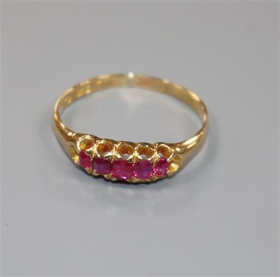 An early 20th century 18ct gold and graduated five stone ruby half hoop ring, size Q.